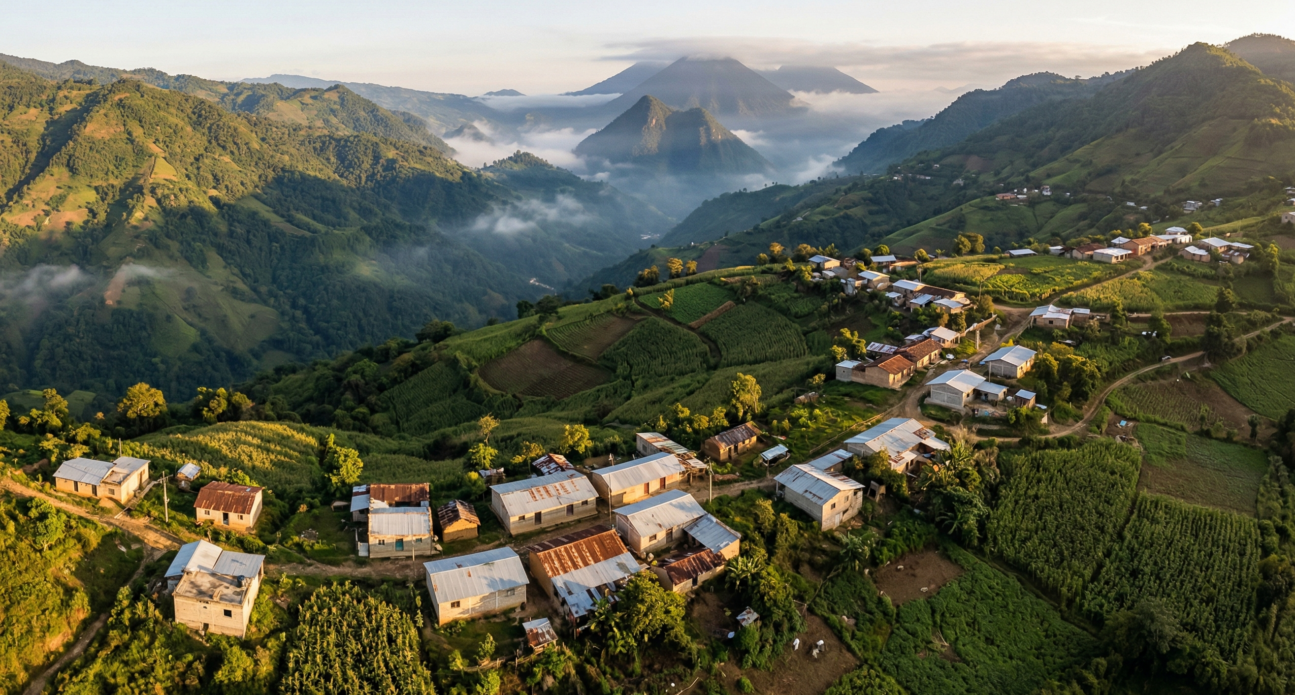 Aerial view of a Chiapas mountain village surrounded by misty green mountains